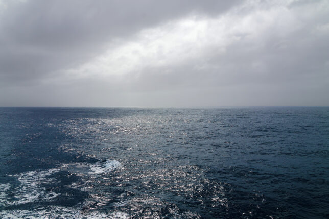 a body of water with clouds in the sky