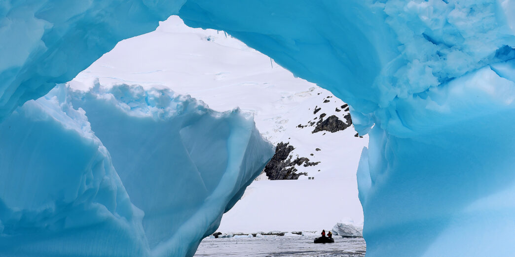 a group of people in a boat in a snowy area