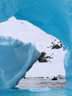 a group of people in a boat in a snowy area