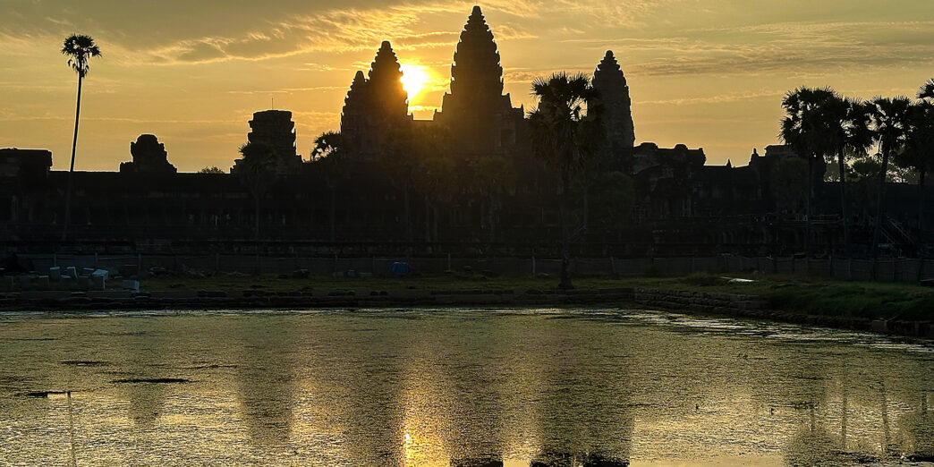 a body of water with a building in the background