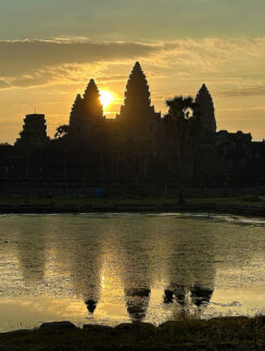a body of water with a building in the background