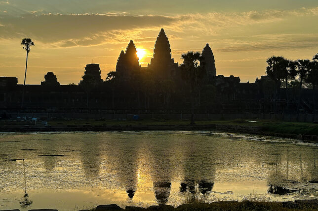 a body of water with a building in the background