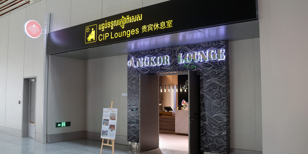 a sign with a lit up sign in front of a building