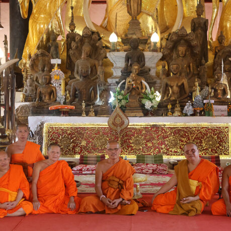 a group of people in orange robes