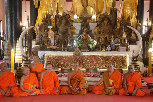 a group of people in orange robes