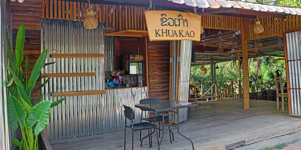 a small wooden building with a table and chairs